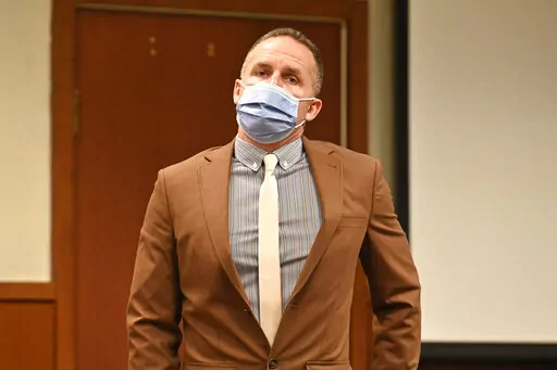 Former Louisville police officer Brett Hankison prepares to leave the courtroom during a recess, Wednesday, Feb. 23, 2022, during his trial in Louisville, Ky.   Prosecutors begin their case against Hankison, charged with wanton endangerment for shooting through Breonna Taylor's apartment into the home of her neighbors during botched police raid that killed Taylor.  (AP Photo/Timothy D. Easley, Pool)