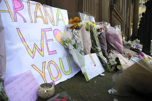 Flower tributes at St Ann's square, Manchester, England, on May 23, 2017, after a suicide bombing attack at an Ariana Grande concert at the Manchester Arena. Britain's domestic intelligence agency didn't act swiftly enough on key information and missed a significant opportunity to prevent the suicide bombing that killed 22 people at a 2017 Ariana Grande concert, an inquiry found Thursday, March 2, 2023. (AP Photo/Rui Vieira, File)