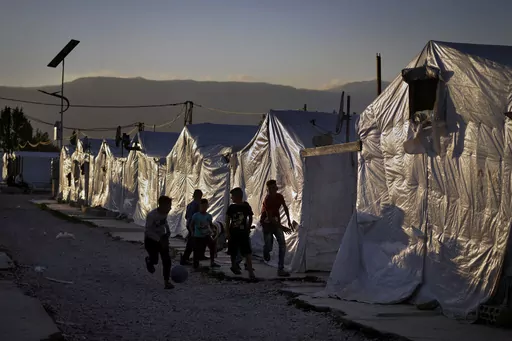 Syrian children play soccer by their tents at a refugee camp in the town of Bar Elias in the Bekaa Valley, Lebanon, July 7, 2022. Against the backdrop of a worsening economic crisis and political stalemate, Lebanese officials have launched a crackdown on the country's Syrian refugees. (AP Photo/Bilal Hussein, File)