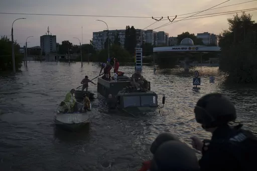 Residents are evacuated from a flooded neighborhood in Kherson, Ukraine, Tuesday, June 6, 2023. A major dam in southern Ukraine has collapsed, flooding villages, endangering crops in the country's breadbasket and threatening drinking water supplies. (AP Photo/Felipe Dana)