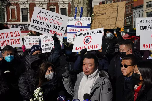 People hold signs during a rally in response to the killing of Christina Yuna Lee in the Chinatown section of New York, Monday, Feb. 14, 2022. Lee was stabbed to death inside her lower Manhattan apartment by a man who followed her from the street into her building, authorities said. (AP Photo/Seth Wenig)