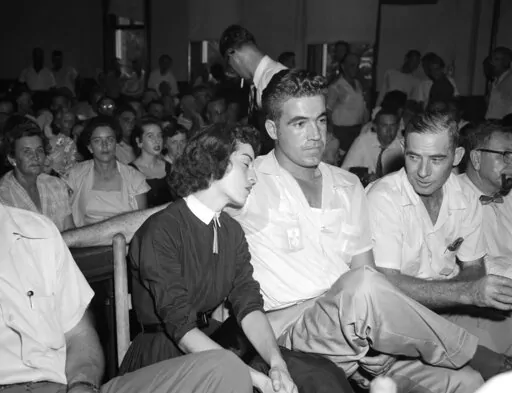 In this Sept. 22. 1955 photo, Carolyn Bryant rests her head on her husband Roy Bryant's shoulder after she testified in Emmett Till murder court case in Sumner, Miss. Stymied in their calls for a renewed investigation into the murder of Emmett Till, relatives and activists are advocating another possible path toward accountability in Mississippi: They want authorities to launch a kidnapping prosecution against the woman who set off the lynching by accusing the Chicago teen of improper advances i