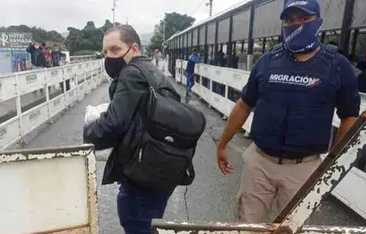 In this photo provided by the Kenemore family, Jerrel Kenemore stands at a Colombian checkpoint in the middle of the Simon Bolivar international bridge connecting San Antonio del Tachira, Venezuela with Villa del Rosario, Colombia, the second week of March 2022. Kenemore, from the Dallas area, is one of at least three American citizens who were quietly arrested in 2022 allegedly trying to enter Venezuela illegally and are being held at a maximum security prison facing long sentences, The Associa