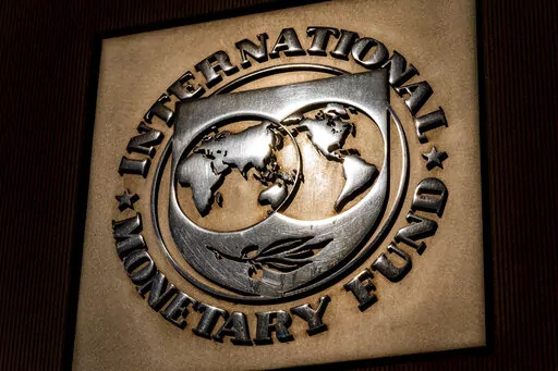 The logo of the International Monetary Fund is visible on their building, April 5, 2021, in Washington. The IMF is facing pressure to eliminate, or at least, reevaluate how it imposes fees on loans it disperses to needy countries like war-torn Ukraine — which is one of the fund's biggest borrowers. (AP Photo/Andrew Harnik)