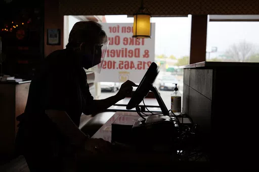 An order is entered by an employee at a diner on Nov. 17, 2020, in Philadelphia. It's never fun to be scammed, but if you're a small business owner falling for a scam can have long-lasting effects on a business, damaging client relationships and profit. (AP Photo/Matt Slocum, File)