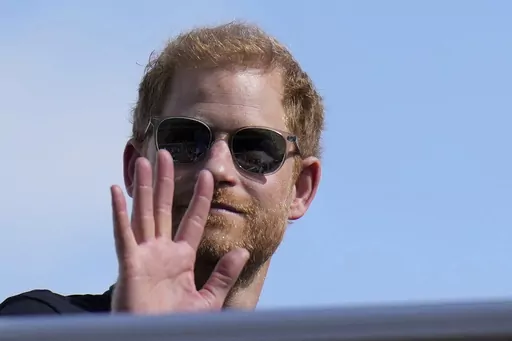 Britain's Prince Harry, The Duke of Sussex, waves during the Formula One U.S. Grand Prix auto race at Circuit of the Americas, on Oct. 22, 2023, in Austin, Texas. Prince Harry dropped his libel lawsuit Friday Jan. 19, 2024 against the publisher of the Daily Mail tabloid following a ruling in which a judge cast doubt on his case. (AP Photo/Nick Didlick, File)