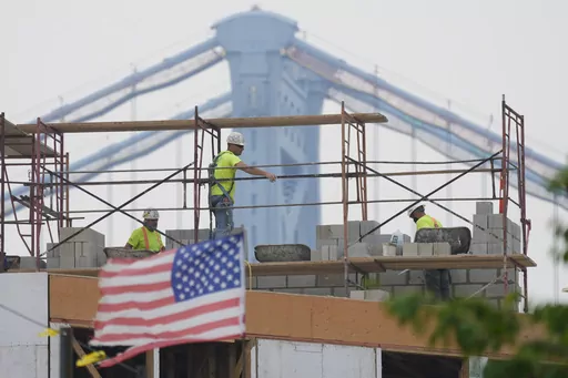 Masons work during hazy conditions in Philadelphia, Wednesday, June 7, 2023. The haze from Canada's wildfires is taking its toll on outdoor workers along the Eastern U.S. who carried on with their jobs even as dystopian orange skies forced the cancelation of sports events, school field trips and Broadway plays. (AP Photo/Matt Rourke, File)