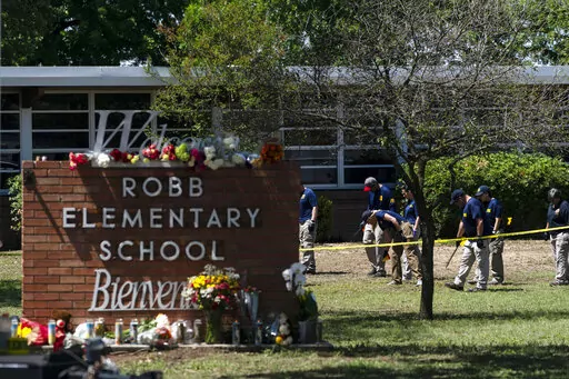 Investigators search for evidences outside Robb Elementary School in Uvalde, Texas, May 25, 2022, after an 18-year-old gunman killed 19 students and two teachers. Uvalde Consolidated Independent School District Police Chief Pete Arredondo, who served as on-site commander during the shooting, said that he's talking daily with investigators, contradicting claims from state law enforcement that he has stopped cooperating. (AP Photo/Jae C. Hong, File)