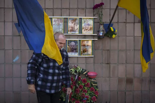 Oleksandr Turovskyi, father of Sviatoslav Turovskyi, in the top right picture, one of the men killed by Russian forces near the building on Yablunska street, leaves after bringing fresh flowers to the place where his son's body was abandoned, in Bucha, Ukraine, Tuesday, March 26, 2024. Days after Russian forces withdrew from the area in late March, in the dramatic first weeks of the full-scale invasion, a photo taken by AP Photographer Vadim Ghirda revealed what happened to the eight men. (AP Ph