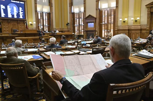 Georgia Sen. Chuck Payne, R-Dalton, foreground, looks at a map as Sen. Nikki Merritt, D-Grayson, background, speaks in opposition of Senate Bill 2EX, newly drawn congressional maps, in the Senate Chambers during a special session at the state Capitol, Nov. 19, 2021, in Atlanta. Lawyers for the state said on Wednesday, Nov. 1, 2023, that it wouldn't appeal a ruling ordering the maps to be redrawn, but wouldn't seek to freeze the ruling during the appeal. (Hyosub Shin/Atlanta Journal-Constitution 