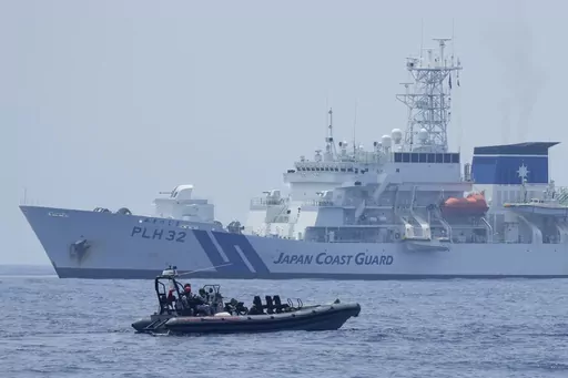 A Philippine Coast Guard rigid hull inflatable boat passes by the Japanese Coast Guard Akitsushima (PLH-32) during a trilateral Coast Guard drill of the U.S., Japan and Philippines, near the waters of the disputed South China See in Bataan province, Philippines, Tuesday, June 6, 2023. The United States, Japan and Australia are planning a joint navy drill in the South China Sea off the western Philippines this week to underscore their commitment to the rule of law in the region after a recent sho