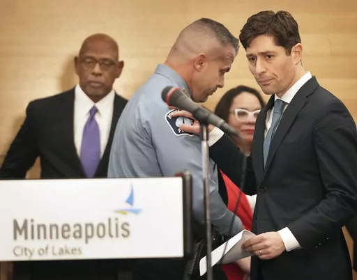 Minneapolis Mayor Jacob Frey, right, pats the shoulder of Minneapolis Police Chief Brian O'Hara after O' Hara spoke during a press conference announcing approval of a sweeping plan to reform policing that aims to reverse years of systemic racial bias Friday, March 31, 2023 at the Minneapolis Public Service Building in Minneapolis. The Minneapolis City Council on Friday approved an agreement with the state to revamp policing, nearly three years after a city officer killed George Floyd. (David Jol