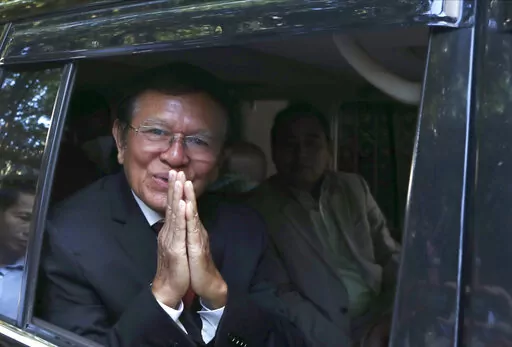 Former President of Cambodia National Rescue Party, Kem Sokha, greets from his car in front of his house in Phnom Penh, Cambodia, Friday, March 3, 2023. Cambodia’s beleaguered pro-democracy forces face another day of reckoning Friday, as the country’s most prominent opposition politician not in exile is scheduled to hear the verdict in his trial for treason.(AP Photo/Heng Sinith)