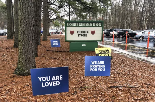 Signs stand outside Richneck Elementary School in Newport News, Va., Jan. 25, 2023. A former assistant principal at a Virginia elementary school has been indicted on eight felony counts of child neglect in the case of a 6-year-old boy who shot and wounded his first-grade teacher in Newport News, Virginia, last year, according to indictments unsealed Tuesday, April 9, 2024, in Newport News Circuit Court. (AP Photo/Denise Lavoie, File)