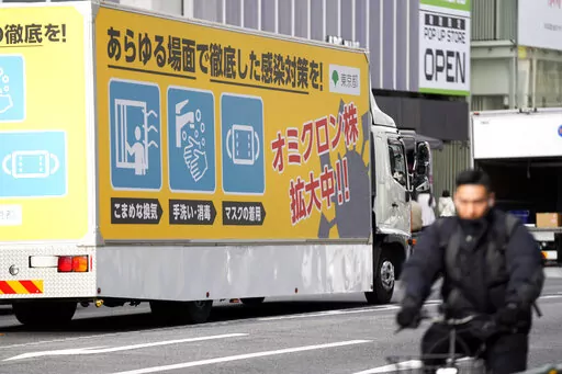 A truck with a public awareness notice on the omicron coronavirus variant moves though a busy shopping street Friday, Jan. 28, 2022, in Tokyo. Scientists and health officials around the world are keeping their eyes on a descendant of the omicron variant that has been found in more than 50 countries, including the United States. (AP Photo/Eugene Hoshiko, File)