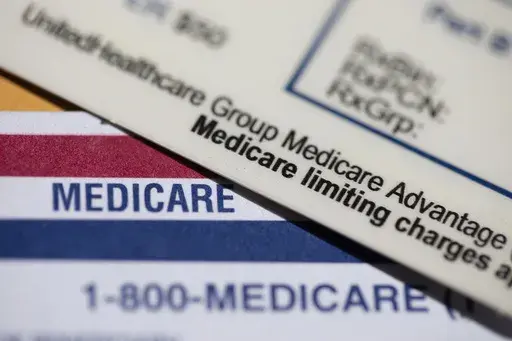 A UnitedHealthcare Group Medicare Advantage PPO card rests on top of a Medicare card is seen in Portland, Ore., June 10, 2024. (AP Photo/Jenny Kane, File)