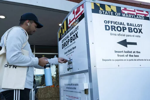 A voter drops his ballot in a drop box at Marilyn J. Praisner Community Recreation Center, during Election Day on Nov. 8, 2022, in Burtonsville, Md. Lawmakers in several Democratic-controlled states are pushing sweeping voting protections this year, reacting to what they view as a broader assault on voting rights by the Supreme Court and Republican-led states. (AP Photo/Jose Luis Magana, File)