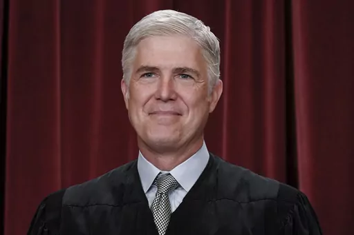 Supreme Court Justice Neil Gorsuch poses for a new group portrait, at the Supreme Court building in Washington, Friday, Oct. 7, 2022. Teaching is encouraged as a way to demystify the Supreme Court while exposing the justices to a cross-section of the public. Yet documents obtained by The Associated Press through public records requests reveal that some all-expense paid trips, particularly to attractive locales stateside and abroad, are light on classroom instruction, with ample time carved out f