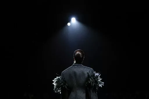 A model wears a creation as part of the Prada Fall/Winter 2022-2023 fashion collection, unveiled during the Fashion Week in Milan, Italy, Thursday, Feb. 24, 2022. (AP Photo/Luca Bruno)