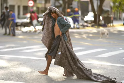 A homeless man crosses a street in an area occupied by drug users known as Crackland, in downtown Sao Paulo, Brazil, May 11, 2023. The decline of Sao Paulo's downtown area has accelerated over the last year, where crack users seem to be everywhere, roaming the central streets of South America's biggest city. (AP Photo/Andre Penner, File)