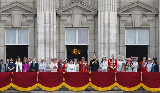 Britain's Queen Elizabeth II, surrounded by members of the family, stand on the balcony of Buckingham Palace to watch the fly past after the Trooping The Colour parade, in central London, Saturday, June 14, 2014. The balcony appearance is the centerpiece of almost all royal celebrations in Britain, a chance for the public to catch a glimpse of the family assembled for a grand photo to mark weddings, coronations and jubilees. (AP Photo/Lefteris Pitarakis, File)
