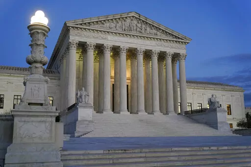 Light illuminates part of the Supreme Court building at dusk on Capitol Hill in Washington, Nov. 16, 2022. The Supreme Court has agreed to hear an appeal arising from a murder-for-hire ordered by the onetime leader of a violent international crime ring. The justices said Tuesday they will review the case of Adam Samia, who is serving a life sentence for killing a real estate broker in the Philippines. (AP Photo/Patrick Semansky, File)