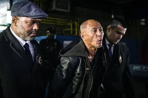 Weng Sor is walked by New York Police Department detectives out of the 68th Precinct in the Brooklyn borough of New York on Tuesday, Feb. 14, 2023. Sor was charged Tuesday with murder and attempted murder after he went on a deadly rampage with a U-Haul truck a day earlier in New York City. (AP Photo/Stefan Jeremiah)