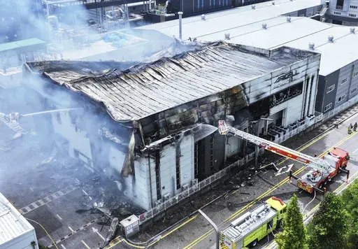 Firefighters work at the site of a burnt lithium battery manufacturing factory in Hwaseong, South Korea, Monday, June 24, 2024. (Hong Ki-wonj/Yonhap via AP)