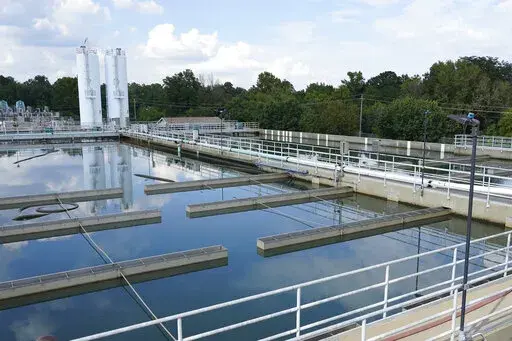 Clouds are reflected off the City of Jackson's O.B. Curtis Water Treatment Facility's sedimentation basins in Ridgeland, Miss., Sept. 2, 2022. Officials in Jackson said the city's water system, which partially collapsed in late August, was experiencing “fluctuating” pressure on Saturday, Dec. 24, amid frigid temperatures. (AP Photo/Rogelio V. Solis, File)