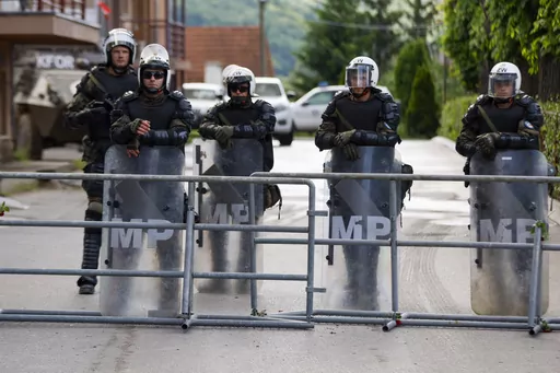Polish soldiers, part of the peacekeeping mission in Kosovo KFOR, guard a municipal building in the town of Zvecan, northern Kosovo, Tuesday, May 30, 2023. Troops from the NATO-led peacekeeping force in Kosovo have used metal fences and barbed wire to beef up positions in a northern town following clashes with ethnic Serbs that left 30 soldiers wounded. (AP Photo/Marjan Vucetic)(AP Photo/Marjan Vucetic)