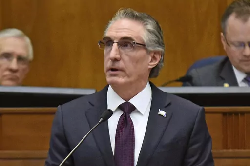 North Dakota Gov. Doug Burgum delivers his budget address before a joint session of the North Dakota Legislature in Bismarck, N.D., Dec. 5, 2018. Burgum signed a bill Monday, April 24, 2023, that limits access to bathrooms, locker rooms and shower rooms for transgender and gender-nonconforming people in several state facilities. (Tom Stromme/The Bismarck Tribune via AP, File)