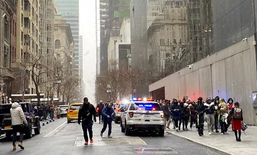 In this photo from a social media post by Scott Cowdrey, people are evacuated from the Museum of Modern Art where a stabbing occurred, Saturday, March 12, 2022, in New York. Police said two people were stabbed inside MoMA and in stable condition at Bellevue Hospital. (Scott Cowdrey via AP)