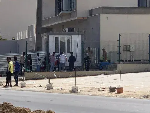 ADDS CONTEXT ABOUT THE UNHCR FACILITY - Migrants line up outside a facility operated by the United Nation’s refugee agency, UNHCR, in Tripoli, Libya on Sept. 6, 2022. It’s one of the few safe places for migrants in the war-torn country. For years, powerful militias and traffickers have taken advantage of the desperation of migrants fleeing war and poverty and trying to reach Europe from Libya’s shores. (AP Photo)