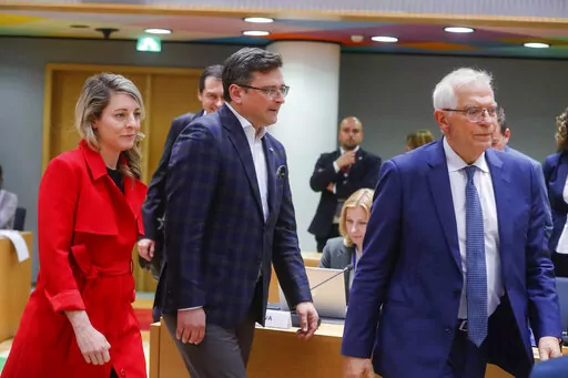 Ukraine's foreign minister Dmytro Kuleba, center, Canada's foreign minister Melanie Joly, left, and European Union foreign policy chief Josep Borrell arrive at a meeting of EU foreign ministers at the European Council building in Brussels, Monday, May 16, 2022. European Union foreign ministers on Monday will discuss current affairs and have an exchange of views on the Russian aggression against Ukraine and the Global Gateway. (Stephanie Lecocq/Pool Photo via AP)