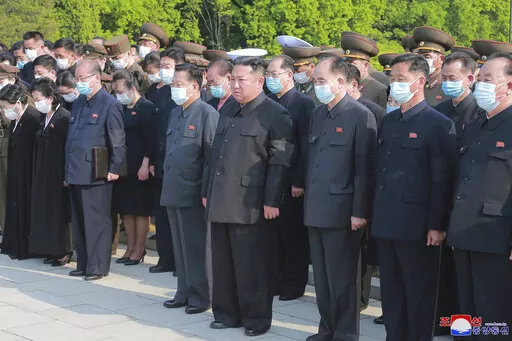 In this photo provided by the North Korean government, North Korean leader Kim Jong Un, center, attends a ceremony for Marshal of the Korean People's Army Hyon Chol Hae at a cemetery in Pyongyang, North Korea Sunday, May 22, 2022. Independent journalists were not given access to cover the event depicted in this image distributed by the North Korean government. The content of this image is as provided and cannot be independently verified. Korean language watermark on image as provided by source r