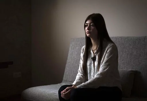 Alina Kapatsyna sits in a house in Dnipro, Ukraine, Friday, Jan. 6, 2023. Men in military uniforms took her mother 45-year-old Vita Hannych away from her house in eastern Ukraine in April. Since the war in Ukraine began, many civilians have been detained by Russian forces and are languishing in jails for months without charges as their relatives seek to find out what's happened to them. (AP Photo/Hanna Arhirova)