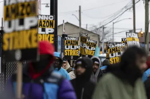 Amazon workers and members of the International Brotherhood of Teamsters picket in front of the Amazon fulfilment center in the Queens borough of in New York, on Friday, Dec. 20, 2024. (AP Photo/Stefan Jeremiah)