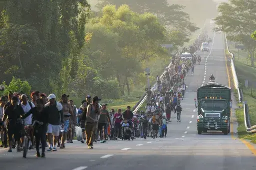 Migrants walk along the highway in Huixtla, southern Mexico, heading toward the country's northern border and ultimately the United States, Thursday, Nov. 7, 2024. (AP Photo/Moises Castillo)