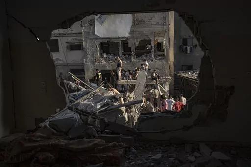 Palestinians look at the destruction after Israeli strikes on the Gaza Strip in Khan Younis, Saturday, Now. 4, 2023. (AP Photo/Fatima Shbair)