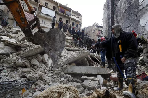 Syrian Civil Defense workers and security forces search through the wreckage of collapsed buildings after a devastating earthquake rocked Syria and Turkey, in Aleppo, Syria, Monday, Feb. 6, 2023. For years, the people of Aleppo bore the brunt of bombardment and fighting when their city, once Syria's largest and most cosmopolitan, was one of the civil war's fiercest battle zones. Even that didn't prepare them for the new devastation and terror wreaked by this week's earthquake. (AP Photo/Omar San