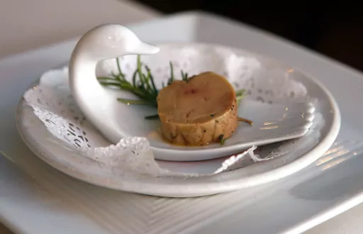 A serving of salt-cured fresh foie gras with herbs is displayed at Chef Didier Durand's Cyrano's Bistrot and Wine Bar in Chicago, Aug. 9, 2006. The Supreme Court is leaving in place a lower court ruling against duck liver lovers, declining Monday, May 22, 2023, to step in and hear a dispute over a California law that bars foie gras from being sold in the state. (AP Photo/M. Spencer Green, File)