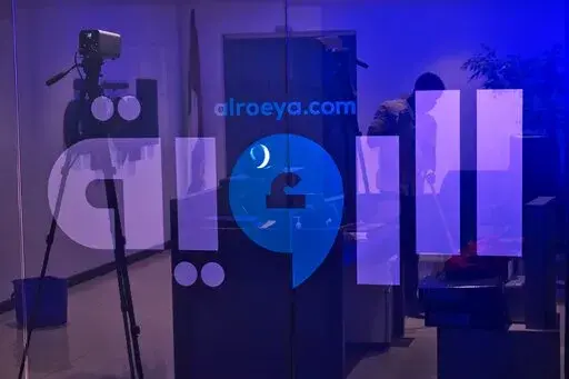 A cleaner sweeps the reception area at the Al Roeya newspaper's offices in Dubai, United Arab Emirates, Sept. 3, 2022. A state-linked newspaper in the United Arab Emirates published a story this summer about a hot-button issue in the country: How Emiratis are coping with high fuel prices. It ended up seeing over 40 people fired and the paper was declared dissolved. The purge at Al Roeya reflects the intense challenges facing local journalists in the autocratic UAE, even as it courts Western medi