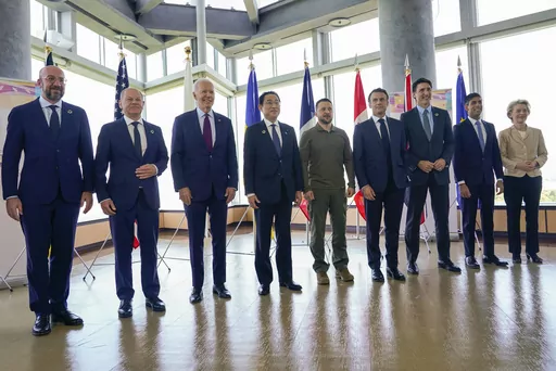 President Joe Biden, third from left, and Ukrainian President Volodymyr Zelenskyy, center, and other G7 leaders pose for a photo before a working session on Ukraine during the G7 Summit in Hiroshima, Japan, Sunday, May 21, 2023. Other leaders from right to left, European Commission President Ursula von der Leyen, Britain's Prime Minister Rishi Sunak, Canada's Prime Minister Justin Trudeau, France's President Emmanuel Macron, Zelenskyy, Japan's Prime Minister Fumio Kishida, Biden, German Chancell