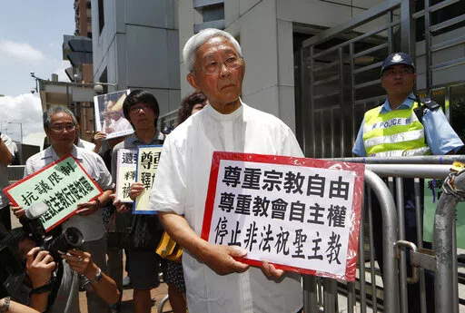 Hong Kong's outspoken cardinal Joseph Zen, center, and other religious protesters hold placards with "Respects religious freedom" written on them during a demonstration outside the China Liaison Office in Hong Kong, Wednesday, July 11, 2012. Reports say a Roman Catholic cardinal and three others have been arrested in Hong Kong on suspicion of colluding with foreign forces to endanger Chinese national security. U.K.-based human rights group Hong Kong Watch said Cardinal Joseph Zen, lawyer Margare