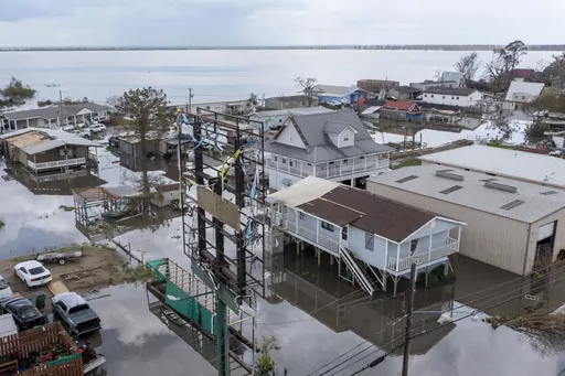 Flood waters surround storm damaged homes on Aug. 31, 2021, in Lafourche Parish, La., as residents try to recover from the effects of Hurricane Ida. Louisiana and nine other states filed a lawsuit against the federal government Thursday, June 1, 2023, to block sharp impending national flood insurance rate increases slated to be phased in over the coming years, saying the steeper costs could cost some people their homes. (AP Photo/Steve Helber)