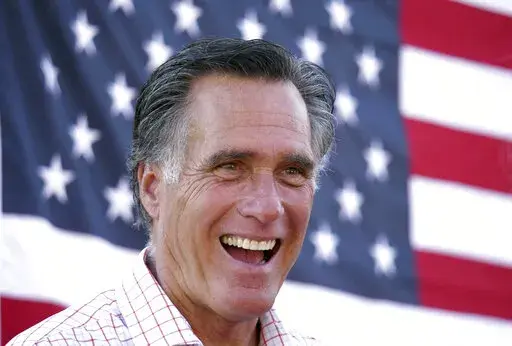In this June 20, 2018, file photo, Mitt Romney smiles during a campaign event in American Fork, Utah. Mitt Romney isn't up for reelection this year, but his name is surfacing in Republican primaries throughout the nation. Candidates are using the label "Mitt Romney Republican" to frame opponents as insufficiently conservative and enemies of the Trump-era GOP Candidates have employed the concept in attack ads and talking points in Michigan, Ohio and Pennsylvania. (AP Photo/Rick Bowmer, File)