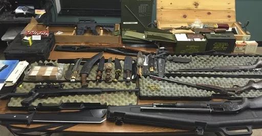 This undated photo provided by the Van Buren County Sheriff's Office in Paw Paw, Mich., shows stolen guns, ammunition and knives that were recovered Sept. 12, 2015, in Antwerp Township, Mich. The rate of guns stolen from cars in the U.S. has tripled over the last decade, making them the largest source of stolen guns in the country, a new analysis of FBI data by the gun-safety group Everytown found. (Van Buren County Sheriff's Office via AP)