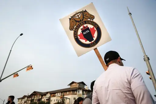 Teamsters Canada Rail Conference members picket outside the CPKC headquarters in Calgary, Alta., Friday, Aug. 23, 2024. (Jeff McIntosh/The Canadian Press via AP)