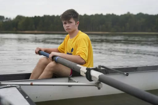 Callum Bradford rows during a club team practice at Jordan Lake, Friday, Oct. 6, 2023, in Apex, N.C. Bradford, a transgender teen from Chapel Hill needed mental health care after overdosing on prescription drugs. He was about to be transferred to another hospital due to a significant bed shortage. A North Carolina hospital network is referring transgender psychiatric patients to treatment facilities that do not align with their gender identities. Though UNC Hospitals policy discourages the pract