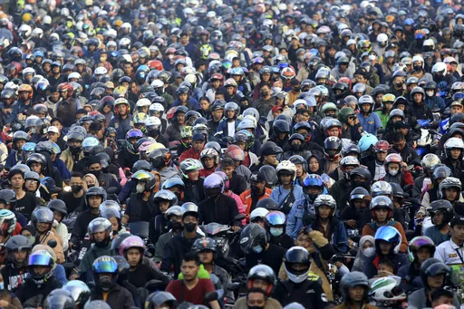 Motorists queue up to board a ferry to cross to Sumatra Island ahead of Eid al-Fitr holiday at Ciwandan Port in Cilegon, Indonesia, Sunday, April 7, 2024. Millions of Indonesians are packing bus and train stations, airports and highways as they head to hometowns to celebrate Thursday's Eid al-Fitr festival with family. (AP Photo/Dziki Oktomauliyadi)